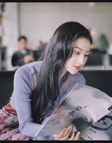 景甜凝神细读剧本手指轻抚页面，窗外微光映照静谧专注身影