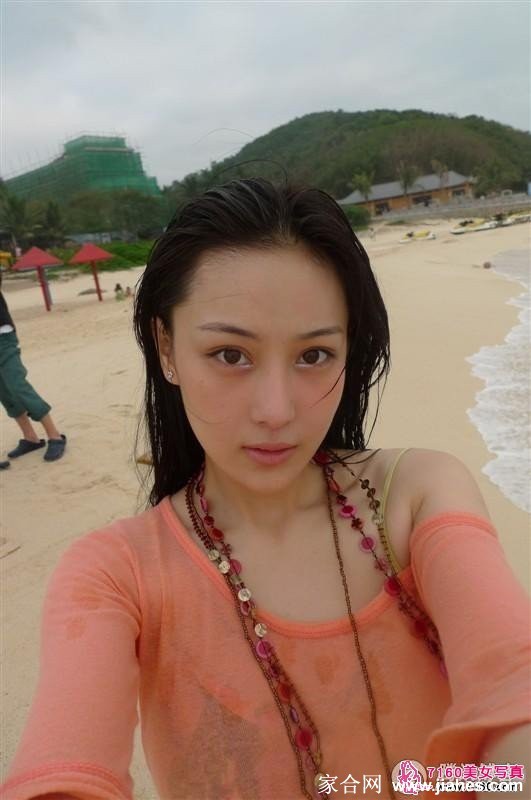 海浪轻涌，打湿了她的裙摆，张馨予在回眸瞬间展露笑颜，洋溢着健康活力的自然气息。